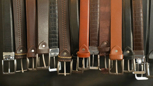 Premium leather belts in varied colors and textures with metal buckles, ideal for formal or commercial use.