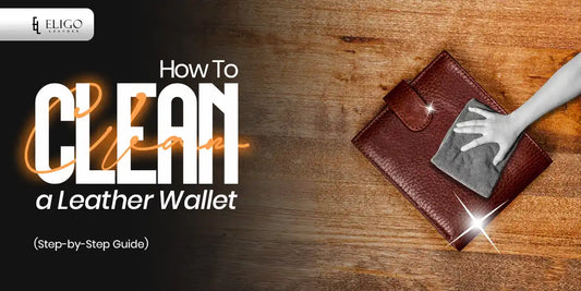A brown leather wallet on a wooden surface being cleaned with a cloth by a hand